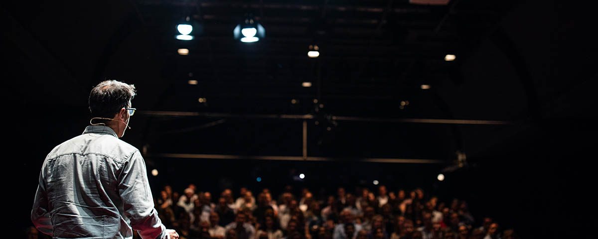 Speaker giving a talk on corporate Business Conference. Audience